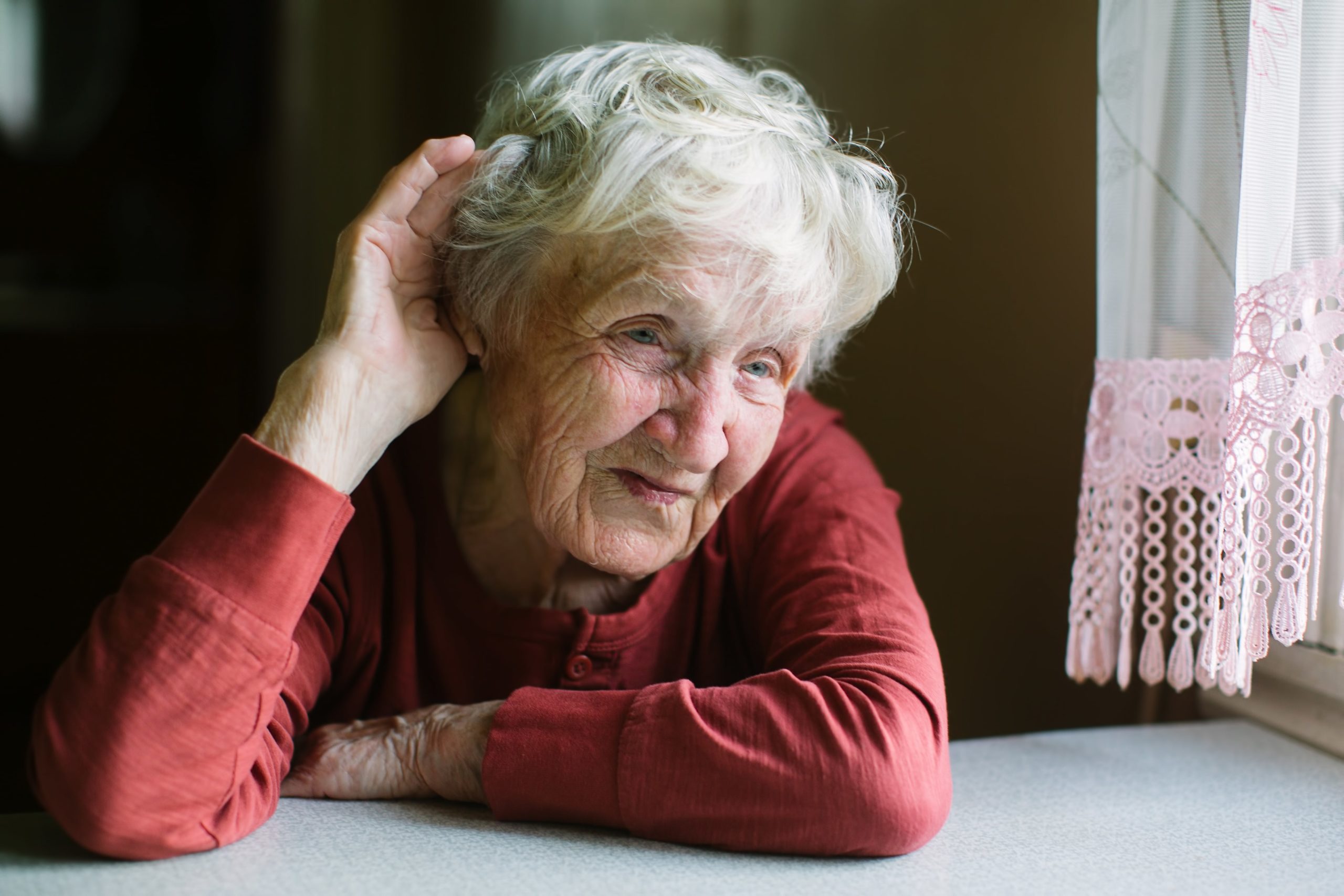Elderly woman suffering with hearing loss