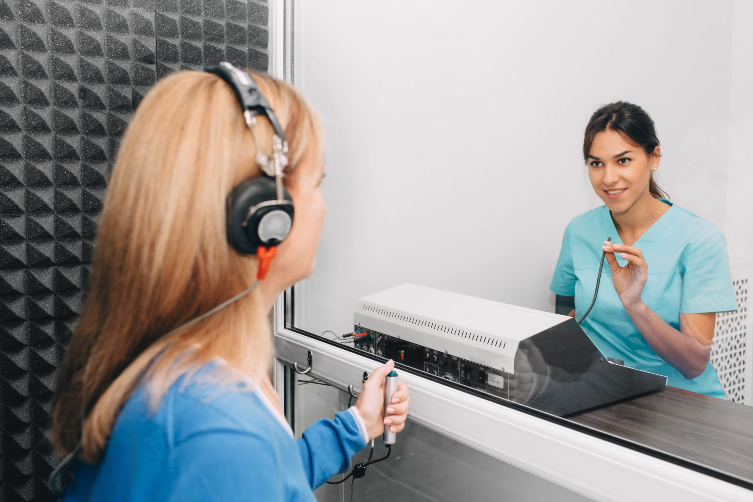 audiologist doing hearing test in special audio room