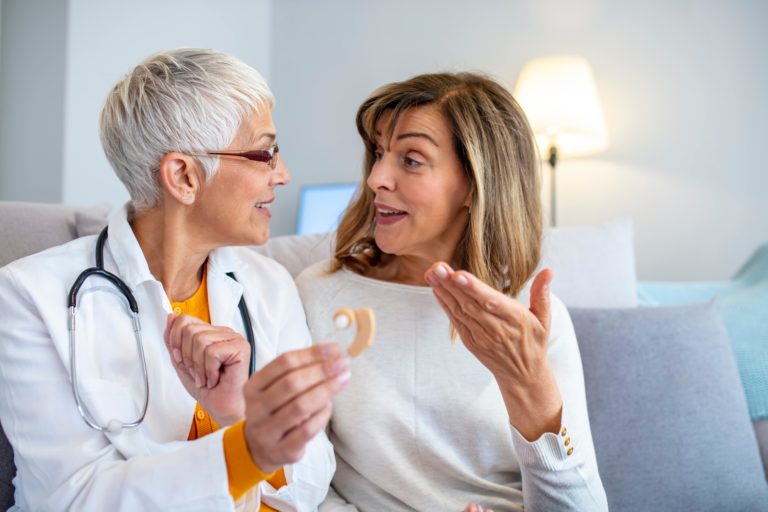 audiologist and patient speaking