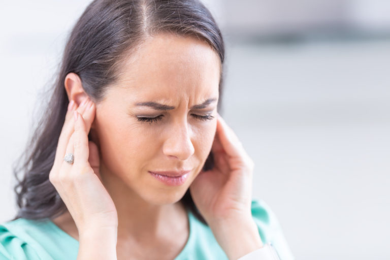 Woman suffering from tinnitus