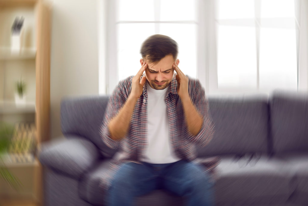 Man feeling dizzy from tinnitus