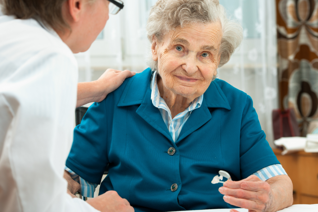Elderly lady speaking to audiologist