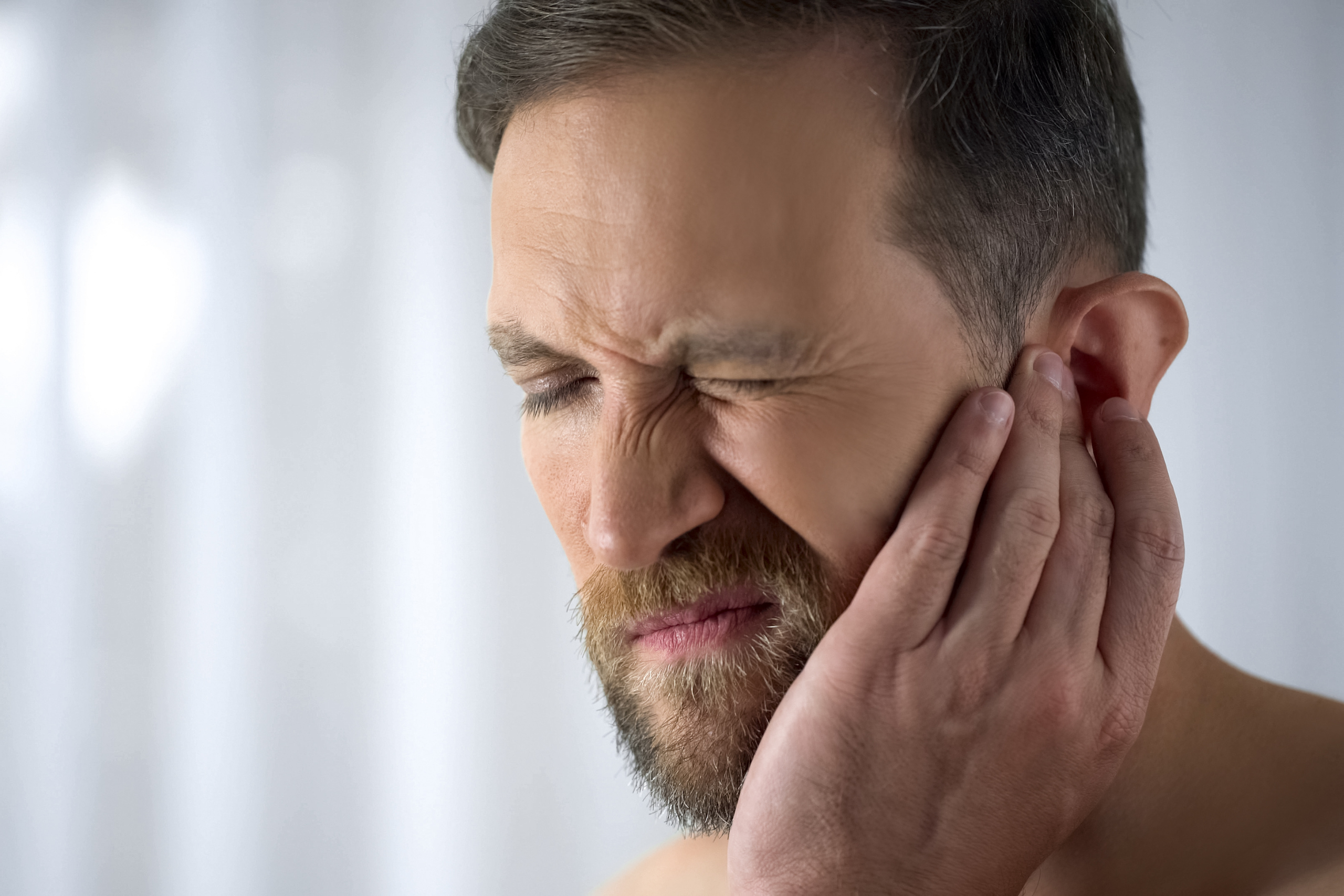 Man suffering from hearing loss