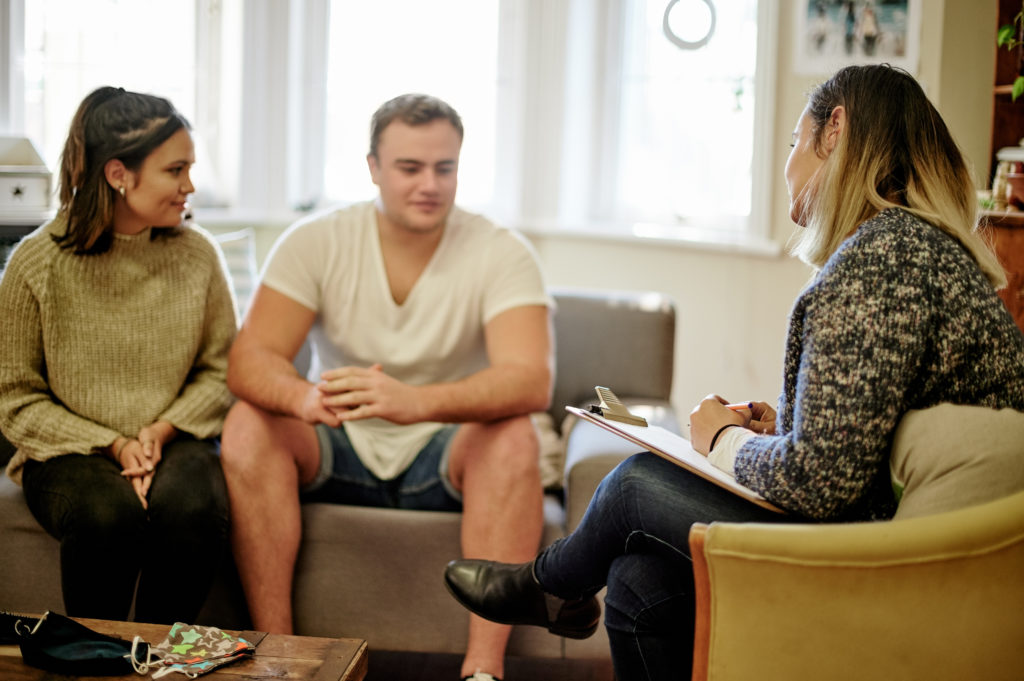 A couple sat speaking with a therapist
